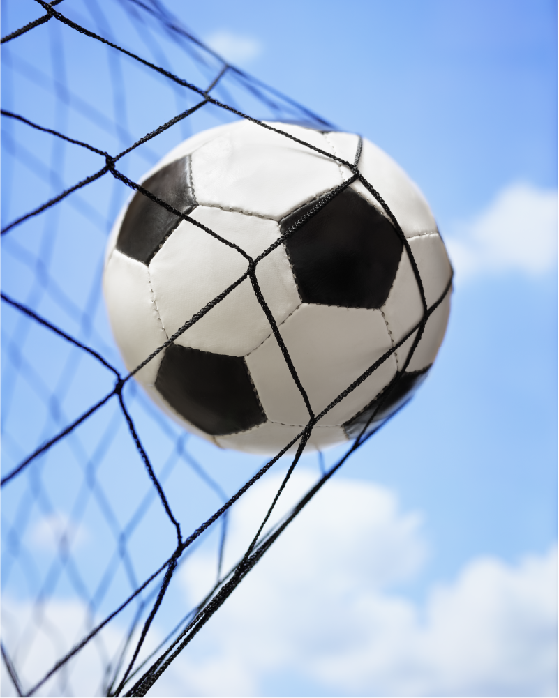 photo of soccer ball going into net for a goal