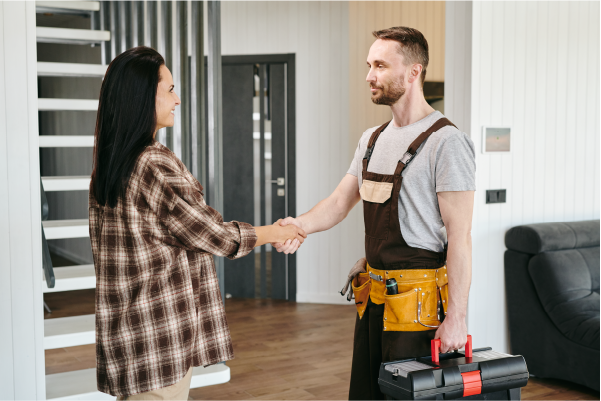 Photo of a woman shaking the hand of a home service professional